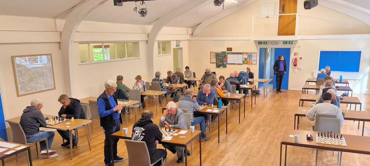View of chess players playing chess in a big hall.