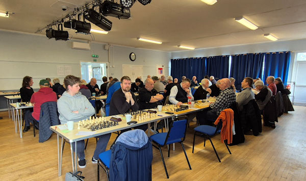 A hall full of people ready to start playing chess
